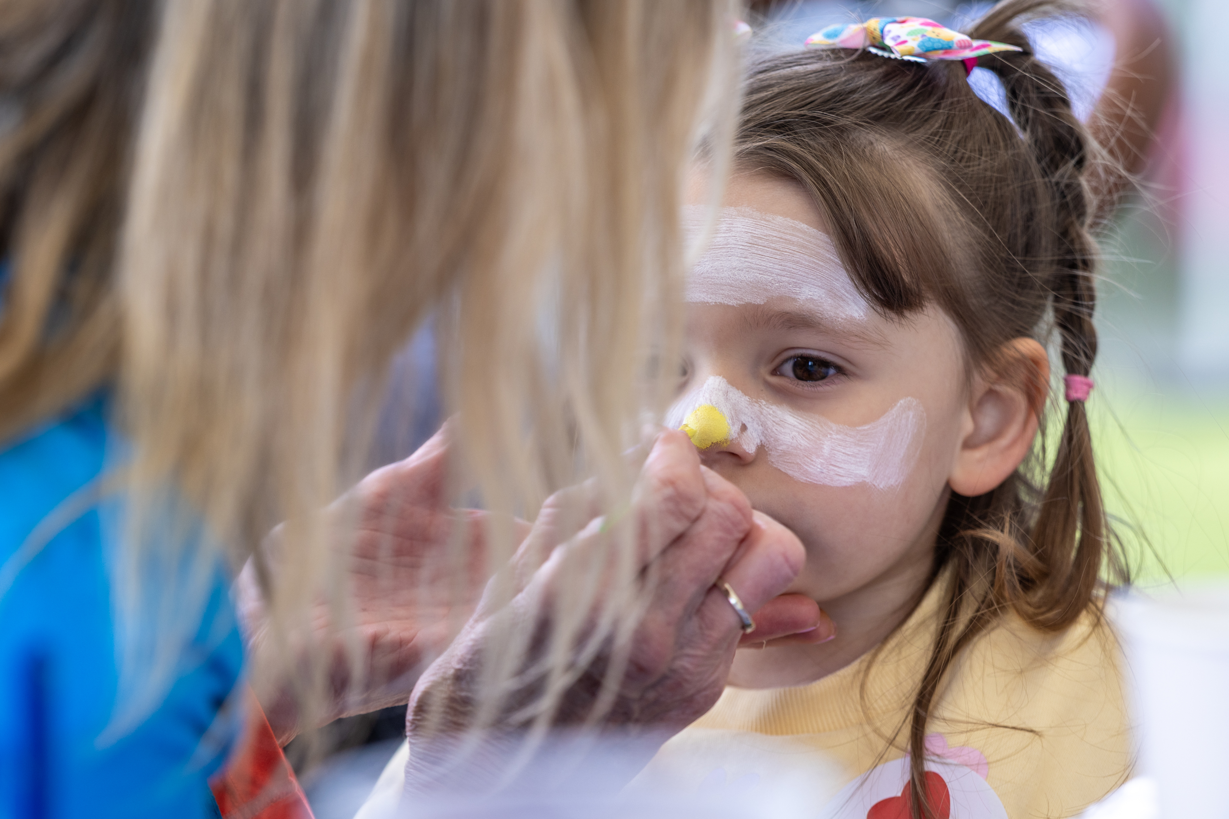 Child getting their face painted. 